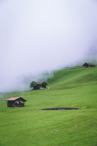 Scenic view of landscape and houses against sky