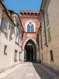 Footpath amidst buildings in city