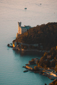 High angle view of sea and buildings against sky