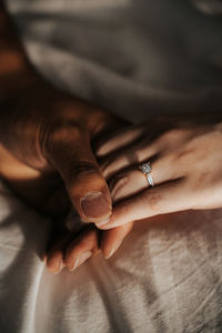 Close-up of couple hands wearing engagement ring
