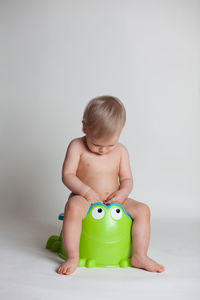 Boy with toy against white background