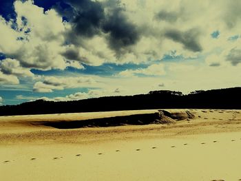 Scenic view of landscape against cloudy sky