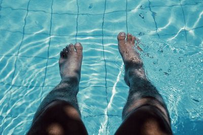 Low section of person in swimming pool