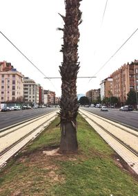 Railroad tracks in city against clear sky