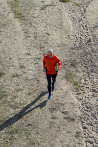 High angle view of senior man running at park