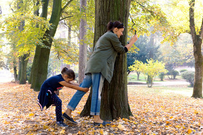 Full length of man standing by tree during autumn