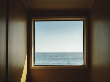 View of sea seen through window