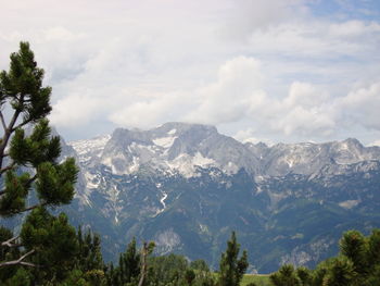 Scenic view of mountains against cloudy sky