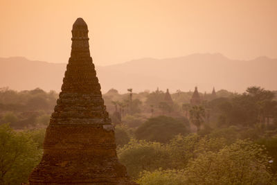 Stupa against clear sky during sunset