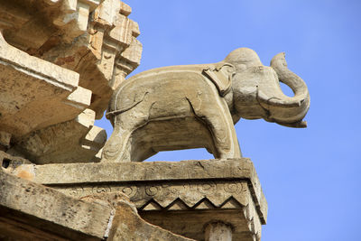 Low angle view of statue against clear blue sky