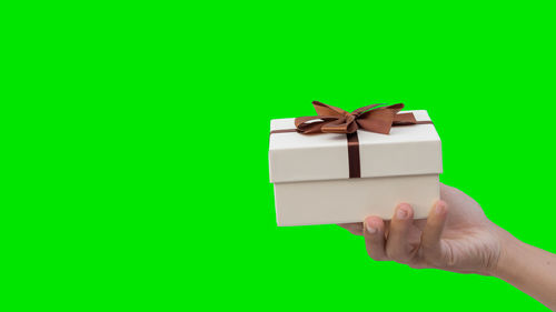 Midsection of man holding box over white background