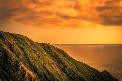 Scenic view of sea against orange sky