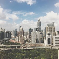 View of skyscrapers against cloudy sky