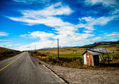 Road by landscape against sky