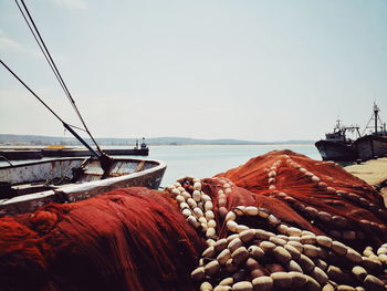 Fishing net on beach against clear sky