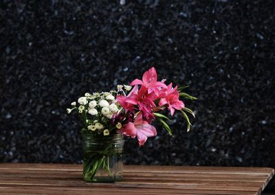 Flowers in vase on wooden table