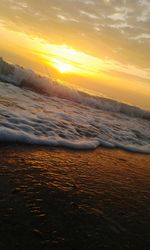 Scenic view of beach against sky during sunset