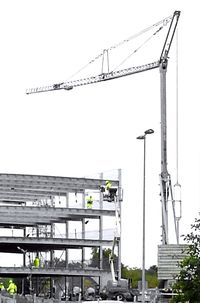 Low angle view of crane against clear sky