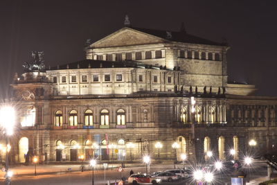 Illuminated building against sky at night