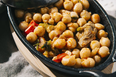 Macro shot of tasty chickpea stew with vegetables, herbs and beef