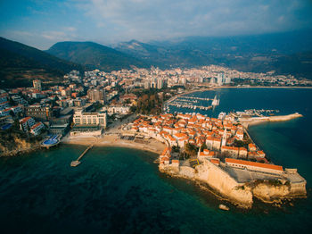 High angle view of buildings by sea against sky