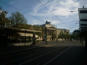 Railroad tracks in city against sky