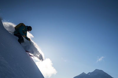 Low angle view of snowcapped mountain against sky