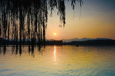 Scenic view of lake against sky during sunset