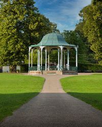 Lawn in park against sky with bandstand