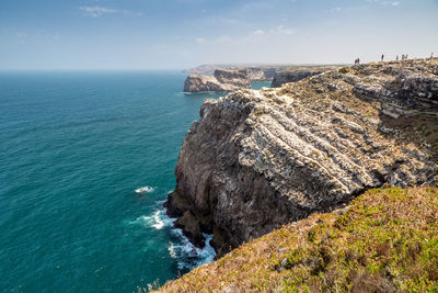 Rock formations by sea against sky