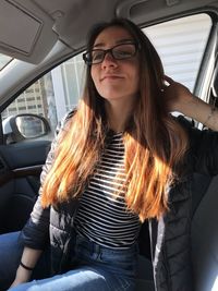 Young woman sitting in car