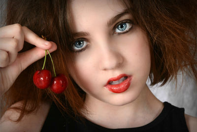 Close-up portrait of girl with cherries