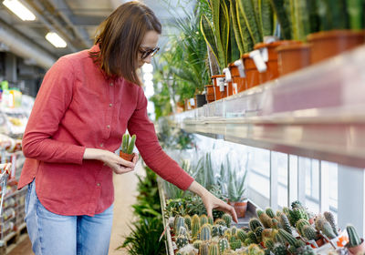 Woman looking away while standing outdoors