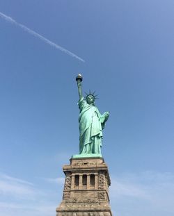 Low angle view of statue against blue sky