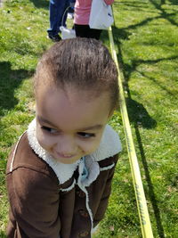 High angle view of smiling girl standing at park