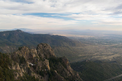 Scenic view of mountains against cloudy sky