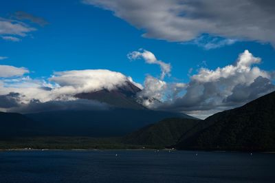 Scenic view of sea against mountain range