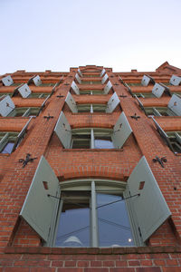 Low angle view of old residential building against sky