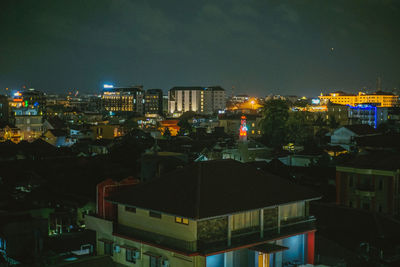 High angle view of illuminated buildings against sky at night