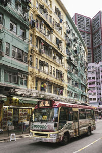 Cars on road by buildings in city