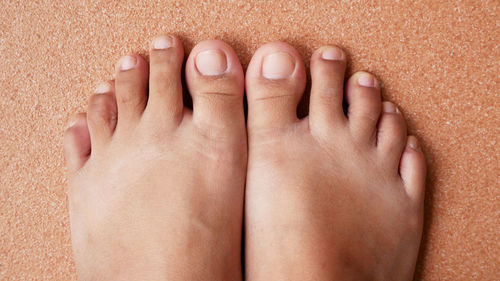 Low section of woman with baby feet