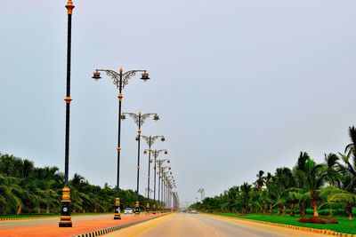 Street light by road against sky