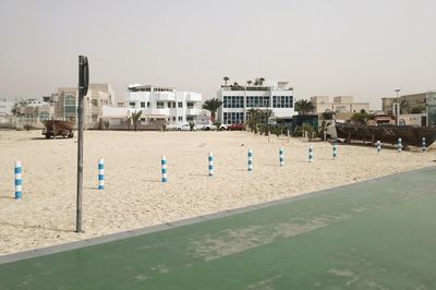 View of beach in city against clear sky