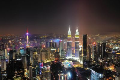 Aerial view of illuminated city buildings at night