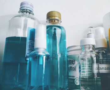 Close-up of bottles on shelf at home