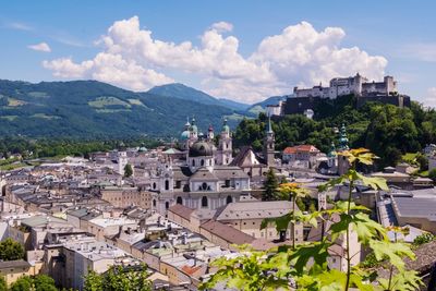 View of townscape against cloudy sky