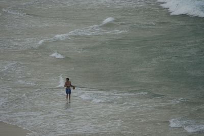 Rear view of man standing on beach