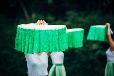 Girls performing with green hand fans