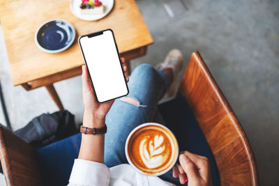 Midsection of woman using mobile phone