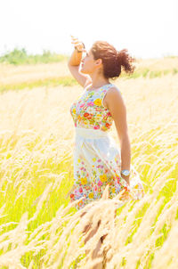 Woman holding flowers on field